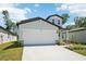 Charming single-Gathering home boasting a two-car garage and beautifully landscaped front yard at 3904 Radiant Mountain Dr, Plant City, FL 33565