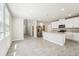 Open kitchen featuring white cabinets, stainless steel appliances, and a large island at 3904 Radiant Mountain Dr, Plant City, FL 33565
