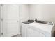 Laundry room featuring a washer, a dryer and a white door at 3904 Radiant Mountain Dr, Plant City, FL 33565