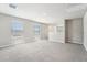 Comfortable living room with large windows, neutral walls, plush carpeting, and ample natural light at 3904 Radiant Mountain Dr, Plant City, FL 33565