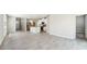 Open-concept living room and kitchen with stainless steel appliances and tile flooring at 3904 Radiant Mountain Dr, Plant City, FL 33565