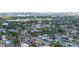 Aerial view of a neighborhood with tree-lined streets, waterways and diverse housing styles, offering city views at 8704 Bay Crest Ln, Tampa, FL 33615