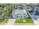 Aerial view of a two-story home, with manicured lawn, driveway, and waterfront access at 8704 Bay Crest Ln, Tampa, FL 33615