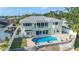 Aerial view of home featuring a backyard pool, spiral staircase, fenced yard and lush landscaping at 8704 Bay Crest Ln, Tampa, FL 33615