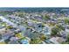 Aerial view of a neighborhood with multiple waterfront homes, docks, and boat lifts at 8704 Bay Crest Ln, Tampa, FL 33615