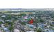 Aerial view of a quiet neighborhood with canals, tree-lined streets, waterways and diverse housing styles, offering city views at 8704 Bay Crest Ln, Tampa, FL 33615
