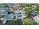 Aerial view showcasing a waterfront home with a pool, boat lift, and canal access at 8704 Bay Crest Ln, Tampa, FL 33615