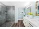 An elegant bathroom featuring a glass enclosed shower and double sinks with a marble countertop at 8704 Bay Crest Ln, Tampa, FL 33615