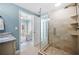 Well-lit bathroom with a glass shower, marble countertop vanity, and view to a furnished living room at 8704 Bay Crest Ln, Tampa, FL 33615