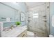 Bright bathroom with marble countertop, double vanity, and a walk-in shower with a glass door at 8704 Bay Crest Ln, Tampa, FL 33615