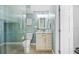 Stylish bathroom featuring a tiled walk-in shower and vanity with marble countertop at 8704 Bay Crest Ln, Tampa, FL 33615