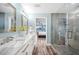 Bathroom featuring double sinks, a glass enclosed shower, and a view into the main bedroom at 8704 Bay Crest Ln, Tampa, FL 33615