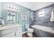 Updated bathroom with a marble-top vanity and bathtub with tiled walls at 8704 Bay Crest Ln, Tampa, FL 33615