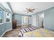 Spacious bedroom with wood floors, ceiling fan, natural light and ensuite bathroom at 8704 Bay Crest Ln, Tampa, FL 33615