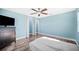 Bedroom with wood floors, ceiling fan, and closet for organized storage at 8704 Bay Crest Ln, Tampa, FL 33615
