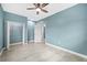 Bright bedroom features tile flooring, ceiling fan, and a closet for ample storage at 8704 Bay Crest Ln, Tampa, FL 33615