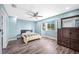 Bright bedroom featuring wood floors, ceiling fan, and dresser at 8704 Bay Crest Ln, Tampa, FL 33615