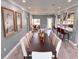 An open dining room features a long table with seating, art pieces, and an open view to the kitchen area at 8704 Bay Crest Ln, Tampa, FL 33615