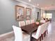 A well-lit dining room features a dining table and comfortable chairs, illuminated by recessed lighting at 8704 Bay Crest Ln, Tampa, FL 33615