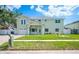 Charming two-story home with a well-manicured lawn and a welcoming front porch at 8704 Bay Crest Ln, Tampa, FL 33615