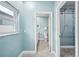 An open hallway with views of the bathroom and closet space offers convenience and accessibility at 8704 Bay Crest Ln, Tampa, FL 33615