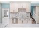 Stylish kitchen with custom cabinets, modern appliances, and a cozy breakfast nook with staircase access at 8704 Bay Crest Ln, Tampa, FL 33615