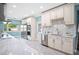 Bright kitchen with stainless appliances, custom cabinets, and easy access to the dining area and backyard at 8704 Bay Crest Ln, Tampa, FL 33615