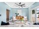 A stylish living room with a ceiling fan, comfortable seating, and access to the backyard at 8704 Bay Crest Ln, Tampa, FL 33615