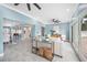 Spacious open-concept living room with dining and kitchen view, tile flooring, and natural light from the pool at 8704 Bay Crest Ln, Tampa, FL 33615