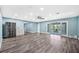 Open concept living space with wood floors, stainless steel appliances and access to the lanai at 8704 Bay Crest Ln, Tampa, FL 33615