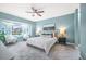 Serene main bedroom features stylish ceiling fan, blue walls, views of the canal and water at 8704 Bay Crest Ln, Tampa, FL 33615