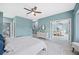 A serene main bedroom features calming blue walls and natural light, along with access to the ensuite bathroom at 8704 Bay Crest Ln, Tampa, FL 33615
