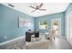 Bright office space with tile floors, ceiling fan, modern desk, and two armchairs at 8704 Bay Crest Ln, Tampa, FL 33615