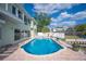 Backyard oasis features a private pool with brick paver patio and lush tropical landscaping at 8704 Bay Crest Ln, Tampa, FL 33615