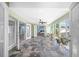 Spacious sunroom features tile floors, a ceiling fan, and abundant natural light at 8704 Bay Crest Ln, Tampa, FL 33615