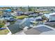Waterfront aerial view featuring docks, boat lifts, and a sailboat at 8704 Bay Crest Ln, Tampa, FL 33615