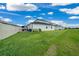 Beautiful backyard featuring a well-manicured lawn and private outdoor space, with a view of the home's exterior at 10549 Torchwood Sea Way, San Antonio, FL 33576