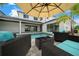 Enjoy the backyard pool and patio, featuring a comfortable lounge set under a cantilever umbrella at 10549 Torchwood Sea Way, San Antonio, FL 33576