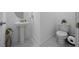 Small bathroom with a modern pedestal sink and toilet, complemented by elegant marble flooring at 10549 Torchwood Sea Way, San Antonio, FL 33576