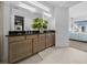 Double vanity in the bathroom featuring granite counters, wood cabinets and sleek lighting at 10549 Torchwood Sea Way, San Antonio, FL 33576