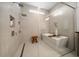 Bright bathroom featuring a walk-in shower and modern tub with accent lighting at 10549 Torchwood Sea Way, San Antonio, FL 33576