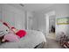 Comfortable bedroom with a soft white rug and a view into an adjacent office space at 10549 Torchwood Sea Way, San Antonio, FL 33576
