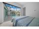 Relax in this bedroom with expansive sliding glass doors opening to the pool, combining indoor/outdoor living seamlessly at 10549 Torchwood Sea Way, San Antonio, FL 33576