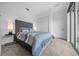 Bright bedroom featuring a queen bed, sleek side tables and sliding glass doors to let the sunshine in at 10549 Torchwood Sea Way, San Antonio, FL 33576