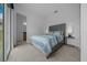 A serene bedroom featuring a plush bed with stylish bedding, creating a comfortable and inviting space at 10549 Torchwood Sea Way, San Antonio, FL 33576