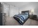 Bright bedroom featuring a stylish bed, matching nightstands, and a dresser with modern hardware at 10549 Torchwood Sea Way, San Antonio, FL 33576