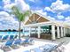 A beautiful pool-side community amenity with a snack bar, with lounge chairs by the beach at 10549 Torchwood Sea Way, San Antonio, FL 33576