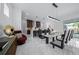 Dining area with sleek table, stylish chairs, and view of the outdoor pool, great for entertaining at 10549 Torchwood Sea Way, San Antonio, FL 33576