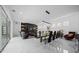 Open-plan dining room with marble floors, modern dining table, and views of the living room at 10549 Torchwood Sea Way, San Antonio, FL 33576