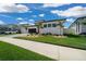 Stunning modern home with a black garage door, desert landscaping, and a vibrant green lawn at 10549 Torchwood Sea Way, San Antonio, FL 33576